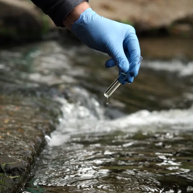 Person taking samples in a river