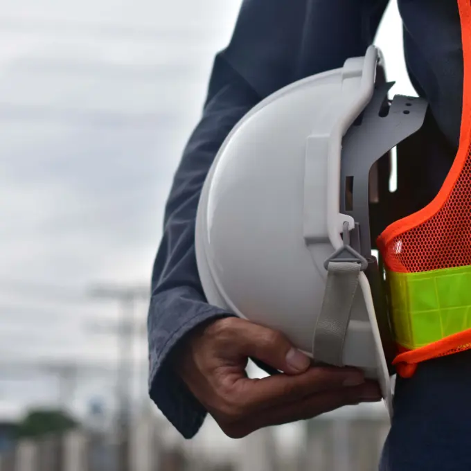 Health and safety - Person holding helmet